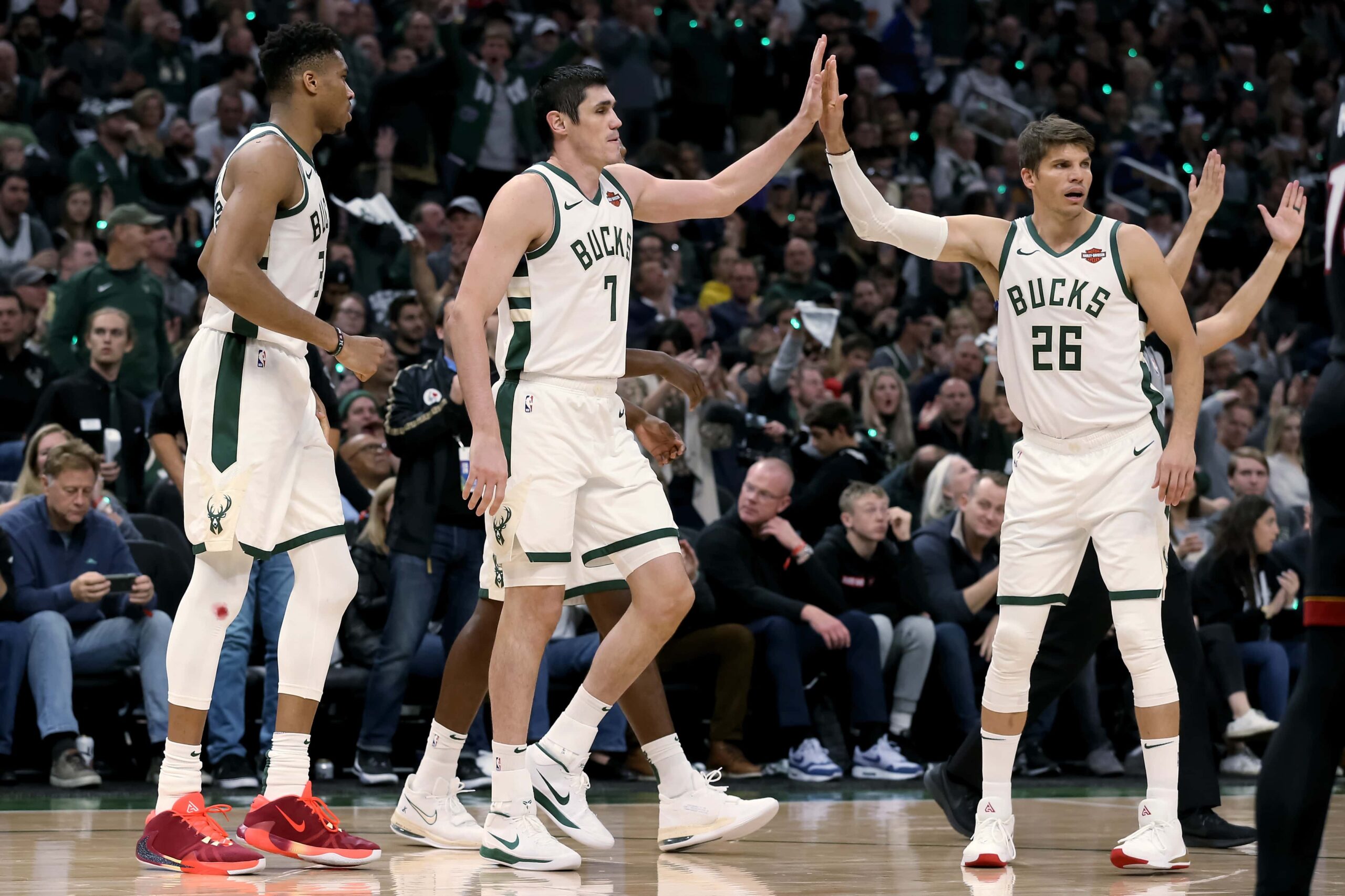 MILWAUKEE, WISCONSIN - OCTOBER 26: Ersan Ilyasova #7 of the Milwaukee Bucks celebrates with Giannis Antetokounmpo #34 and Kyle Korver #26 in the second quarter against the Miami Heat at the Fiserv Forum on October 26, 2019 in Milwaukee, Wisconsin. NOTE TO USER: User expressly acknowledges and agrees that, by downloading and/or using this photograph, user is consenting to the terms and conditions of the Getty Images License Agreement. (Photo by Dylan Buell/Getty Images)